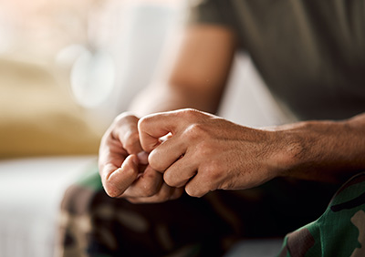 Relaxed hands clasped together in a therapy setting, representing calmness and focus.