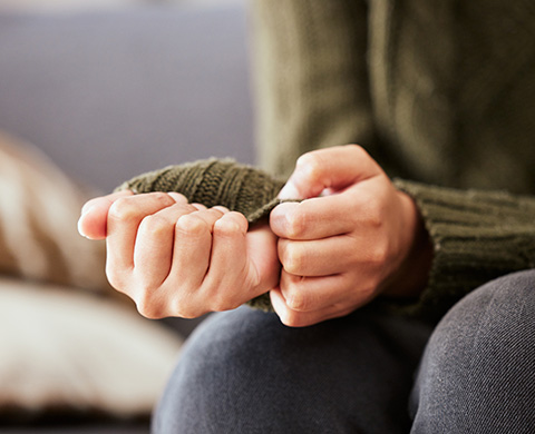Hands gripping wrist, suggesting tension or stress relief.