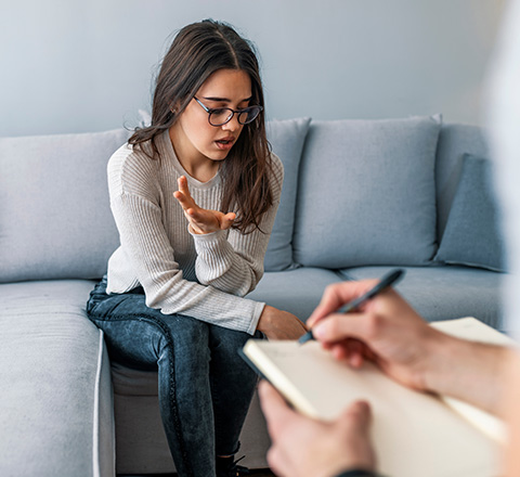 Client discussing concerns during a therapy session in a comfortable setting.